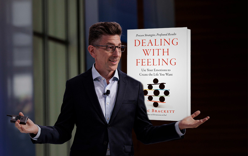 Marc Brackett speaking, with an image of his book, Dealing With Feeling, in the background